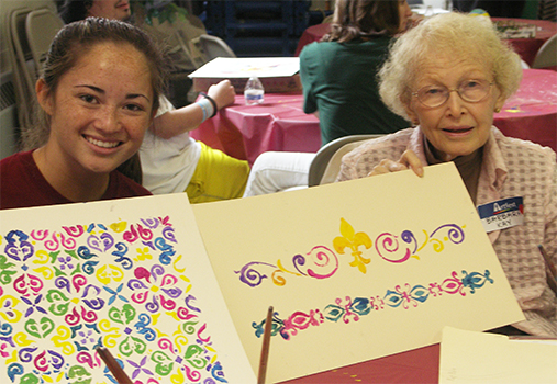 Camryn Jung (left) and Barbara Kay show off their creations at Artfest 2015.