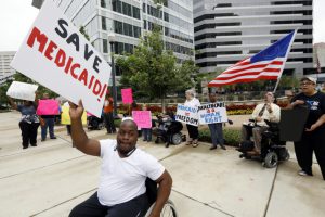 People with disabilities and their supporters protesting proposed Medicaid spending cuts in Washington, D.C.